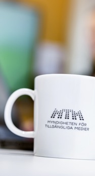 En kaffekopp med MTM:s logotyp på.