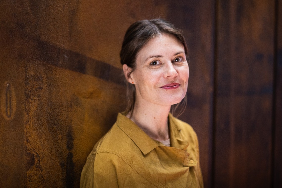 En porträttbild av Lisa Olsson Dahlquist. Lisa har en senapsgul blus och ler. Bilden är länkad till en artikel om samverkansinitiativet.